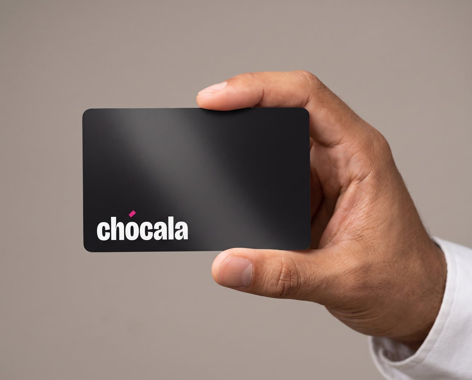 Tarjeta negra mate de Chócala sostenida entre dos dedos